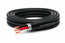 12/3 TECK90 armoured copper cable coiled on a white background with black, red, and white insulated conductors and bare copper ground exposed