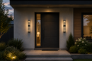 Modern home exterior at dusk featuring 18-inch LED crystal bubble glass outdoor wall sconces with warm architectural lighting beside a contemporary front entrance and landscaped walkway.